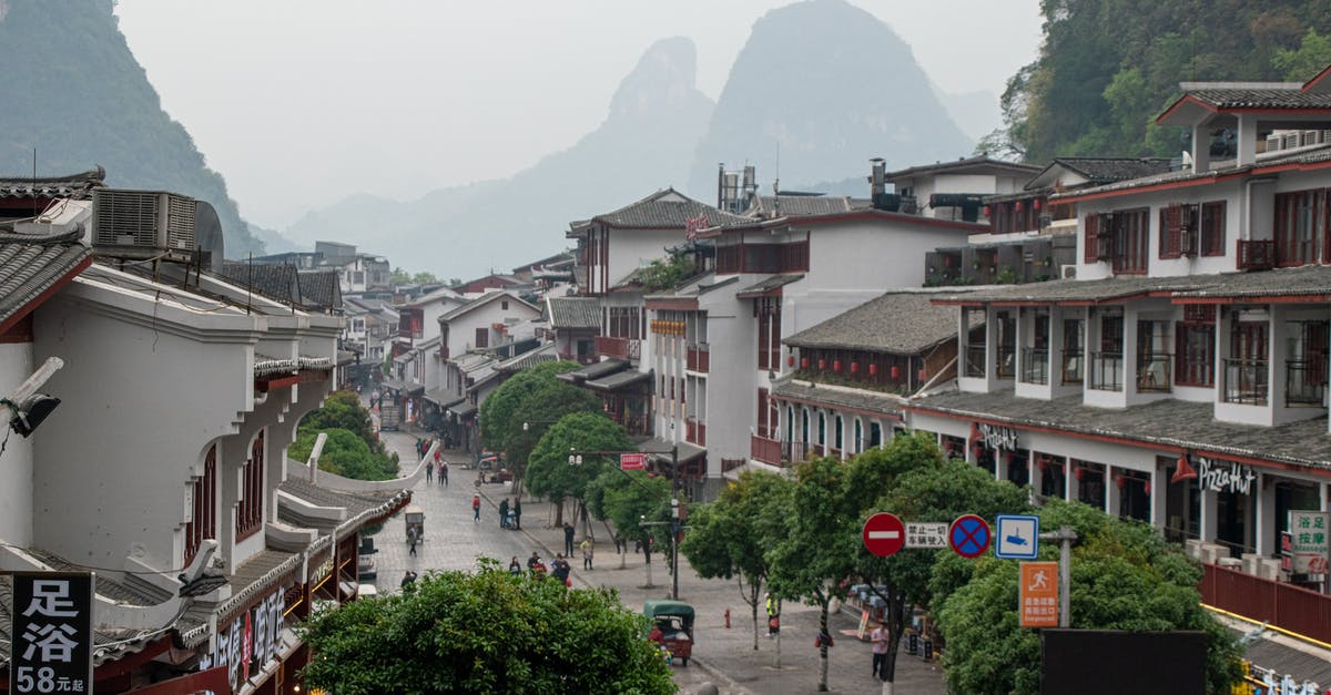 Kazakhstan to China by train in 2019? - People Walking on Sidewalk Near Buildings