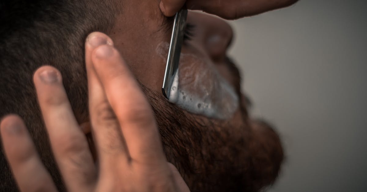 Keeping men's razor blades sharp for traveling - Person Holding Gray Straight Razor