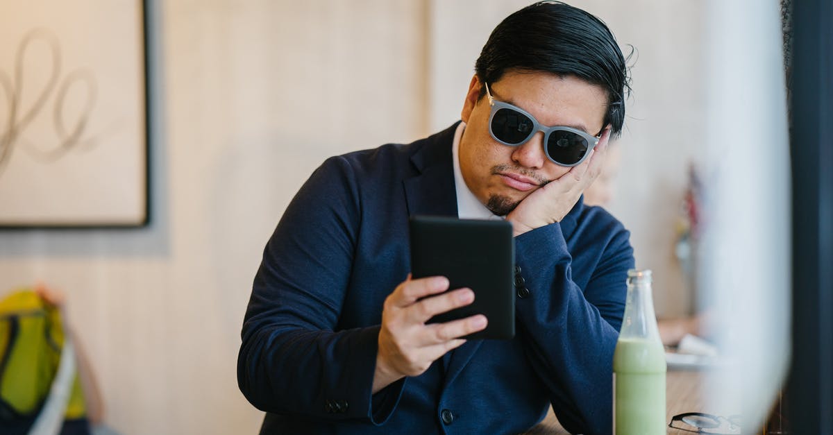 Kindle version of WikiTravel? - Man Wearing Grey Sunglasses Holding Black Tablet 