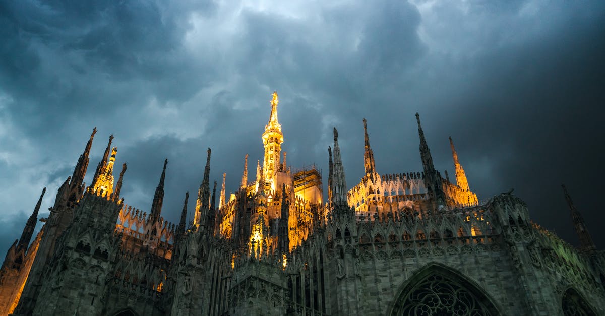 Know the city of origin from an italian passport - Milan Cathedral with glowing sharp spires under overcast sky