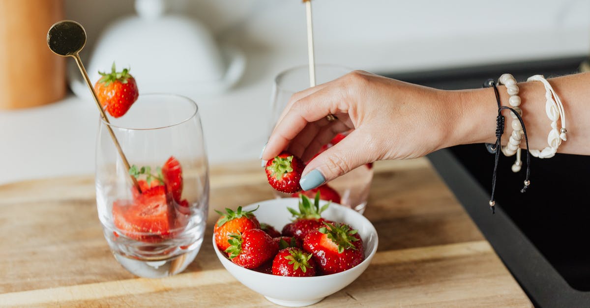 Kosher food on British Airways Buy on Board - Person Holding Red Strawberries in Clear Glass Bowl