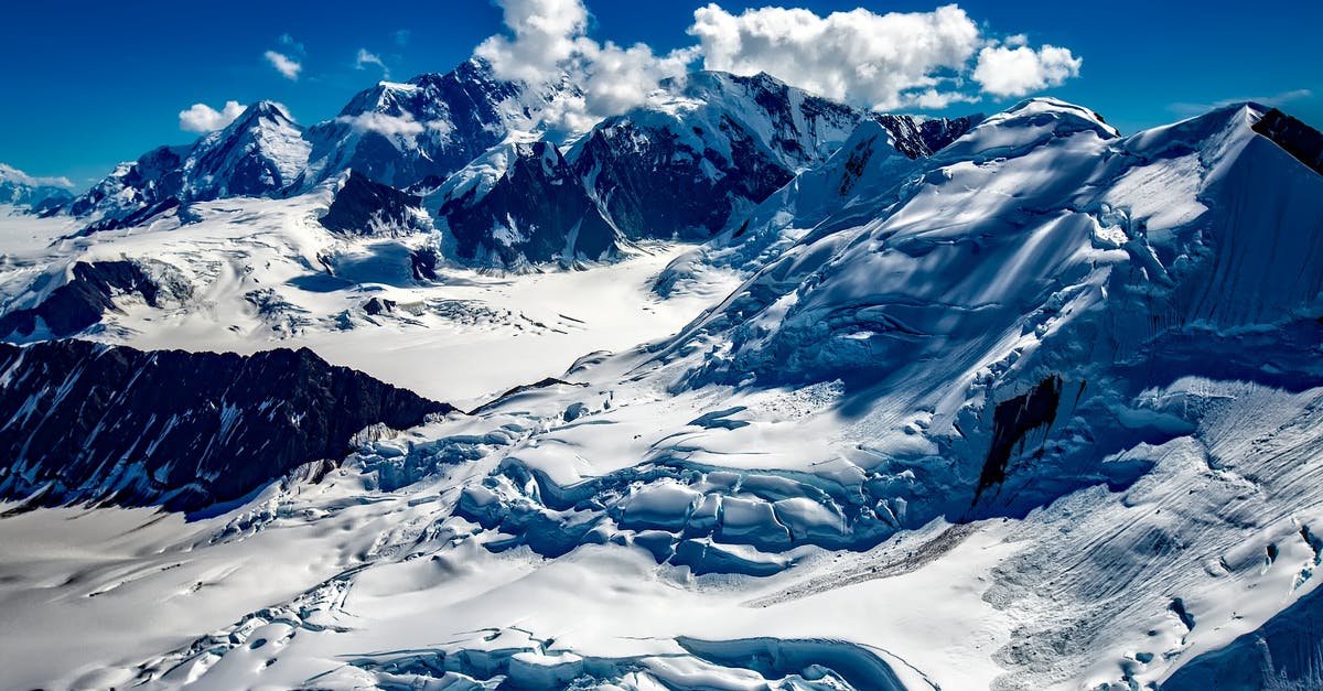 Kuwaiti Travelling to Alaska - Mountain Covered With Snow Under Blue Sky