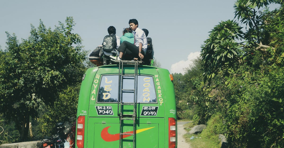 Labuan Bajo to Lombok by bus & ferry [duplicate] - Man in Black Jacket Sitting on Green Van