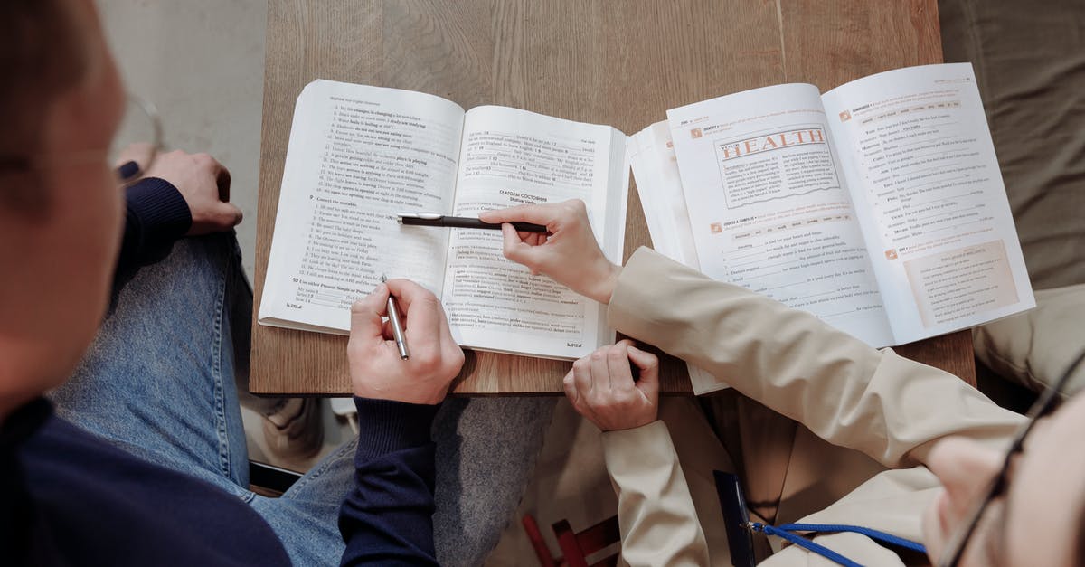 Language schools that teach Mayan languages around Lake Atlitlan, Guatemala? - Person in Brown Coat Holding White Printer Paper