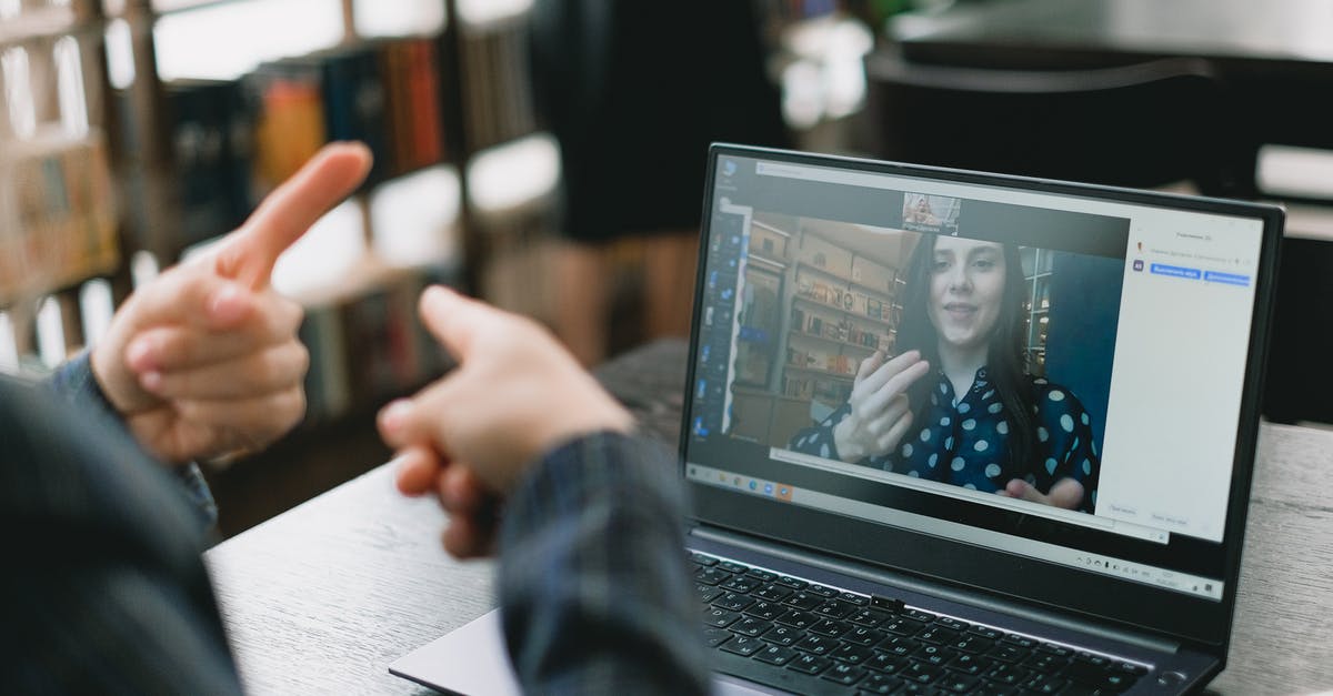 Language to communicate in tourist places in Bratislava? English is sufficient? - Young lady learning sign language during online lesson with female tutor