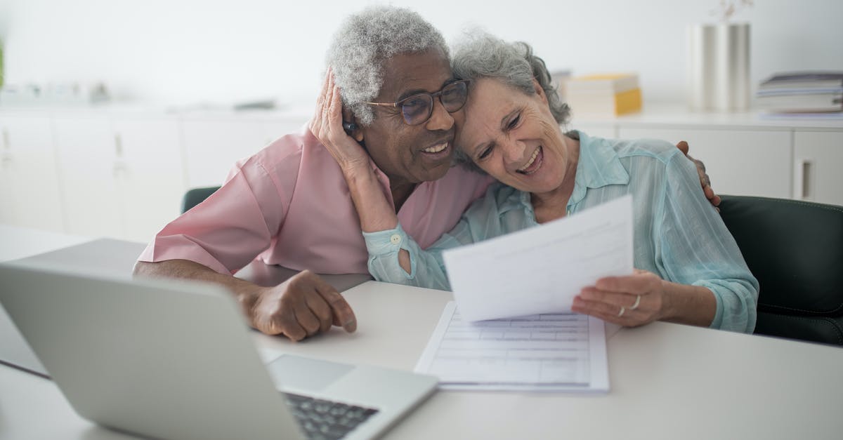 Laptop in cargo hold insurance coverage [duplicate] - A Happy Elderly Couple Holding a Document