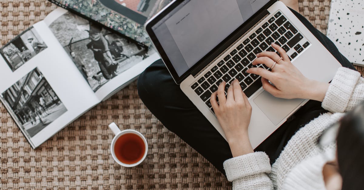 Laptop on overhead bin vs. turbulence [duplicate] - Crop young businesswoman using laptop while drinking tea at home