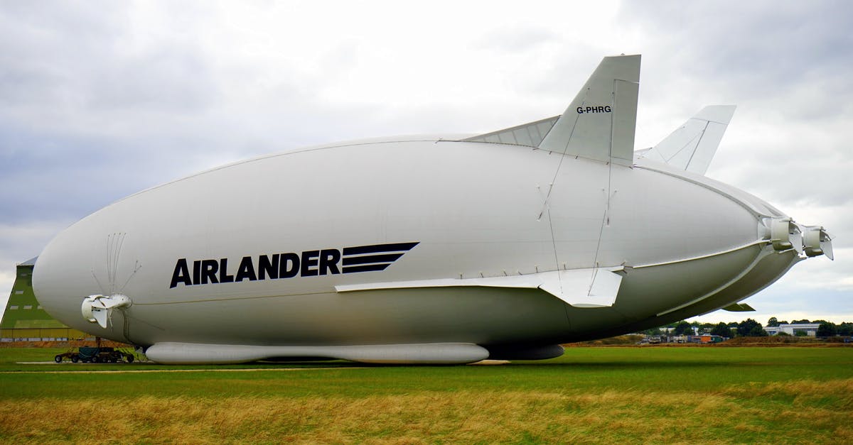 Large tech allowed on Intl. flight? [duplicate] - White Airlander on Green Grass