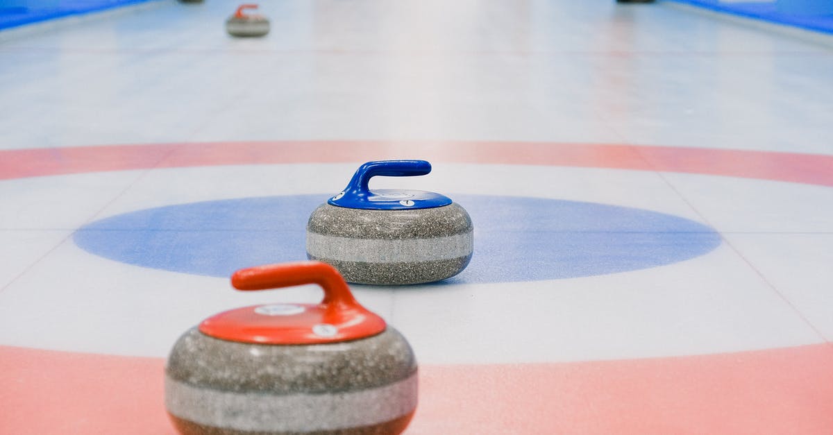 Last minute event tickets for London 2012 Olympic Games - Red and blue handled curling stones placed on circles of house of ice arena while competition