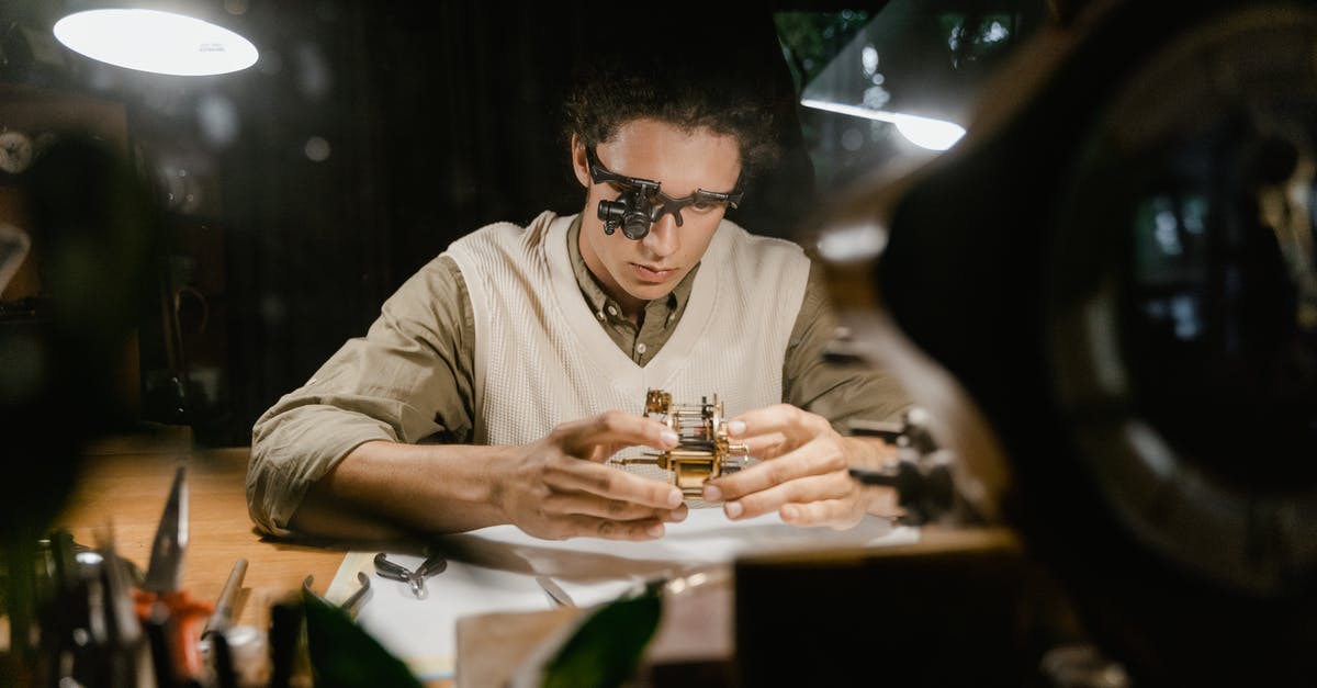 Last minute hotel deals - Man in White Dress Shirt Wearing Black Sunglasses Sitting at Table