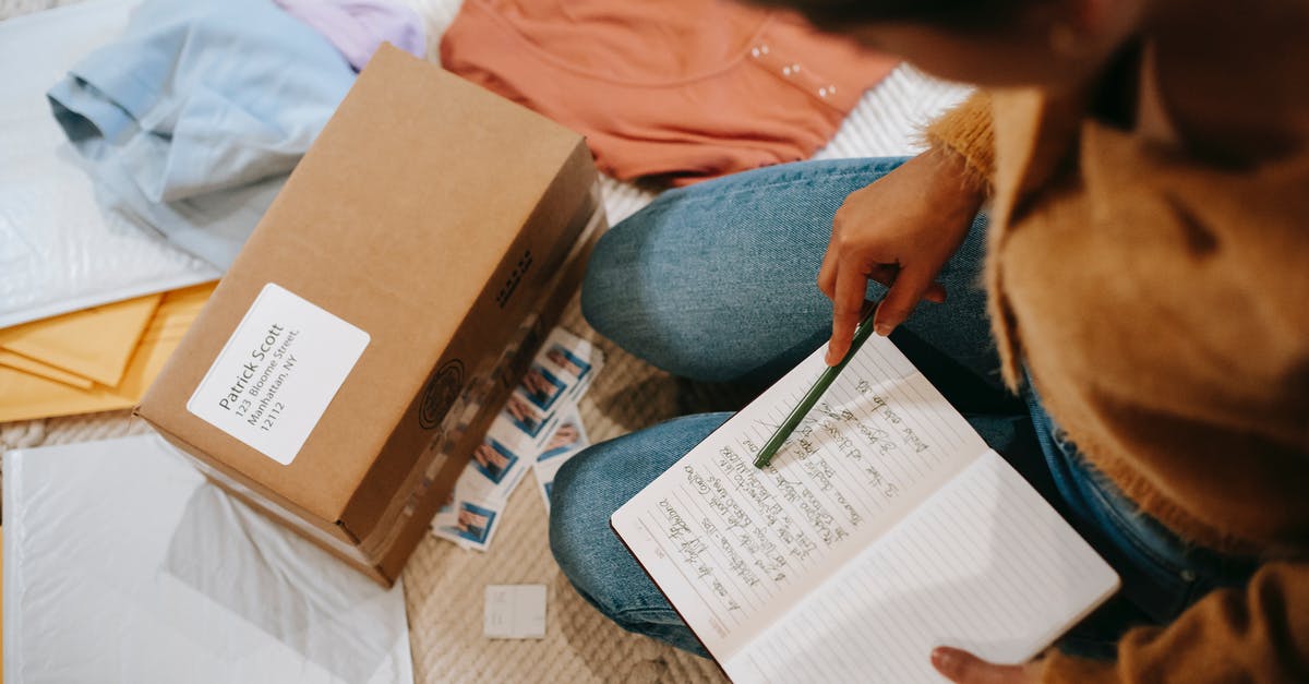 Last name ordered wrongly in airticket - Woman comparing information in notebook and carton box