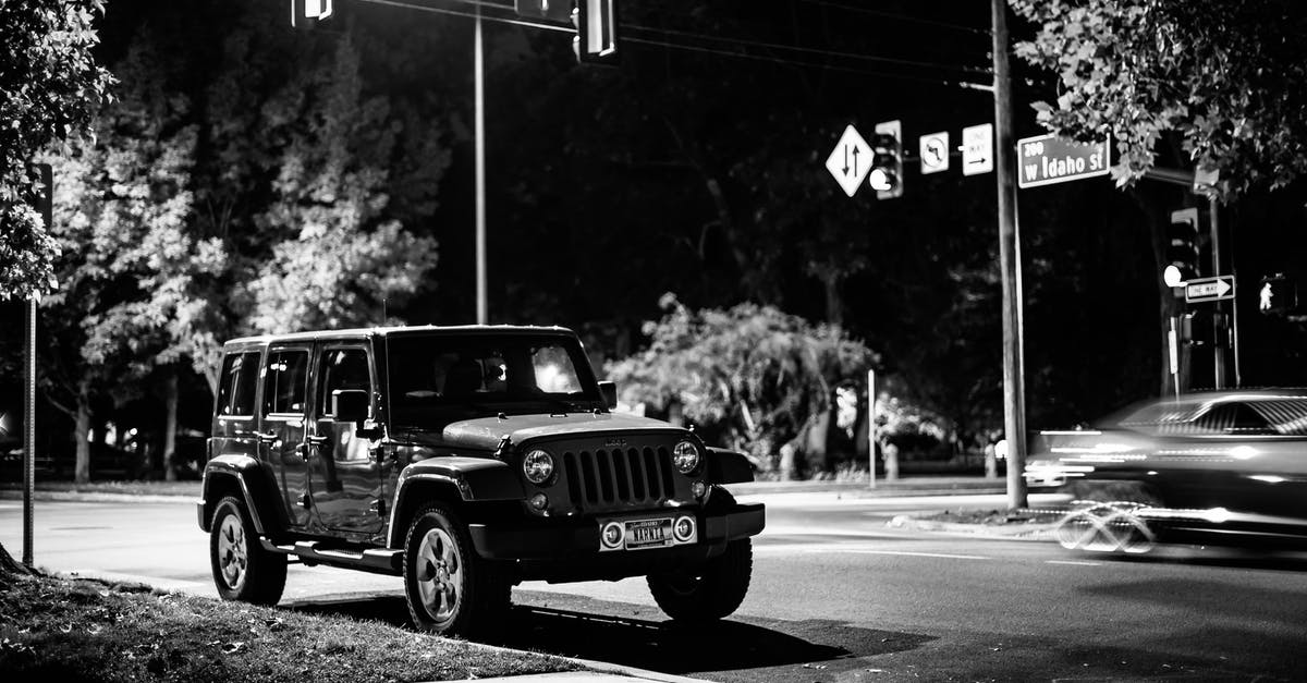 Late evening public transport in Nice - Black and white of contemporary automobile near crossroad with signposts in late evening