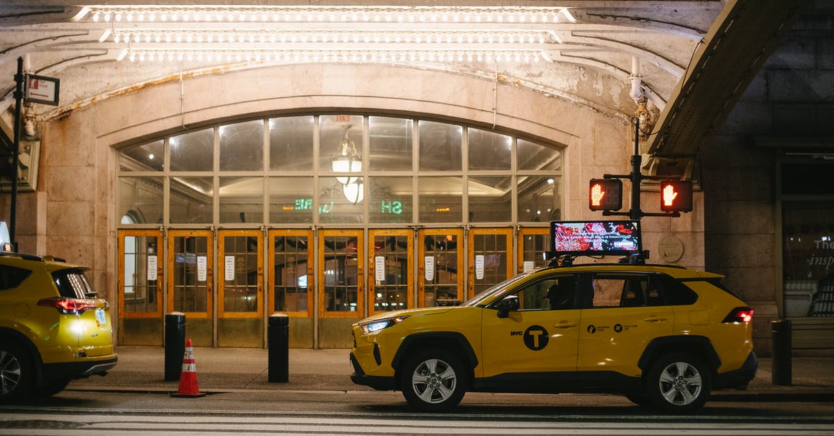 Late night taxis at the Rosslyn (Virginia) Station - Stylish yellow SUV cab parked on road in evening