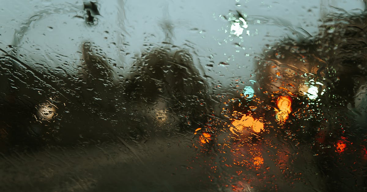 Late night taxis at the Rosslyn (Virginia) Station - Road in modern city street with lights through car window in rainy weather