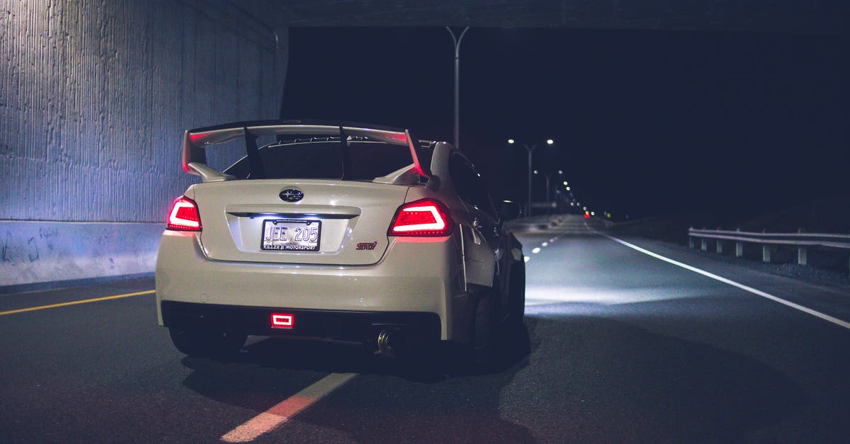 Late night transportation in Leipzig - Sport car with red taillights driving under bridge