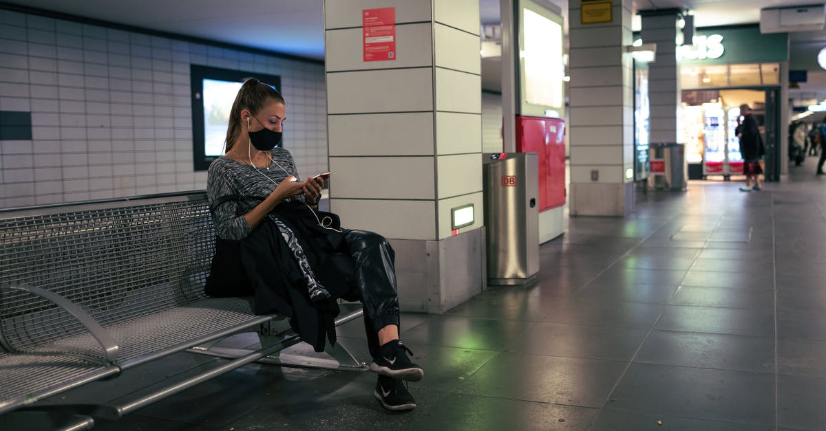 Layover - Guangzhou airport - Man in Black Jacket Sitting on Black Chair