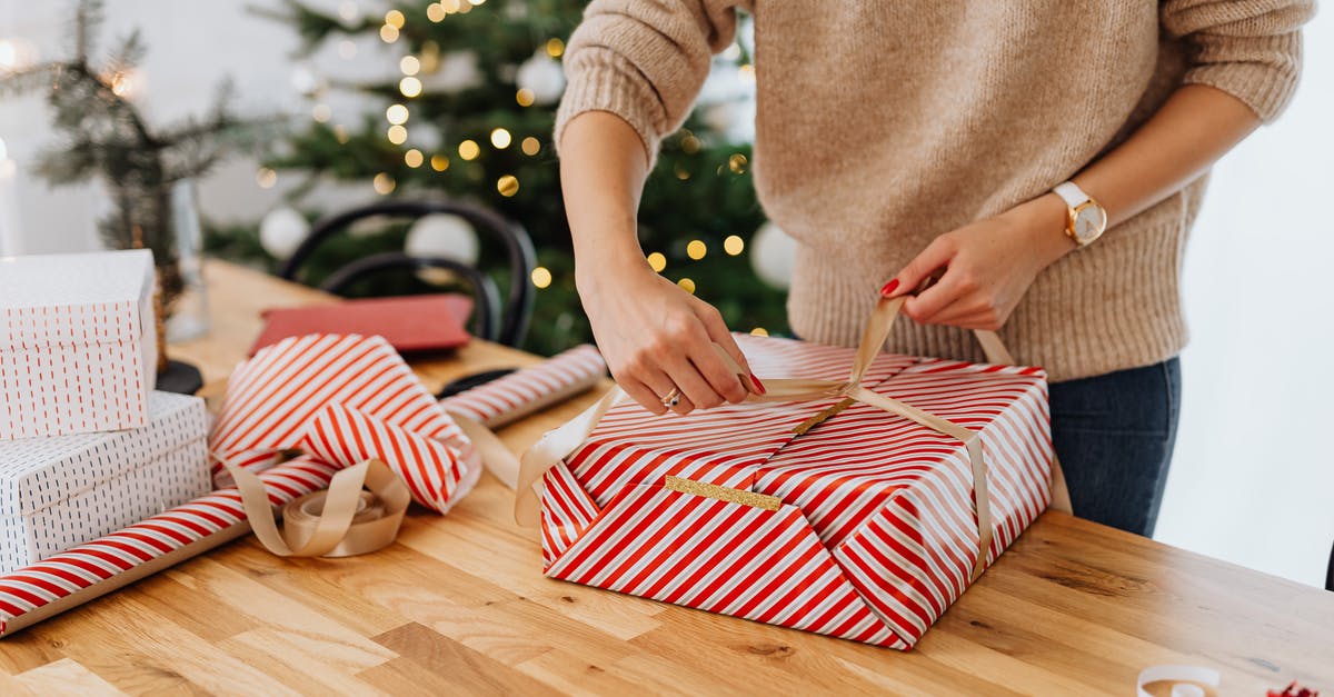 Layover at DEL T3 Holiday Inn - Woman Wrapping Gift near Christmas Tree