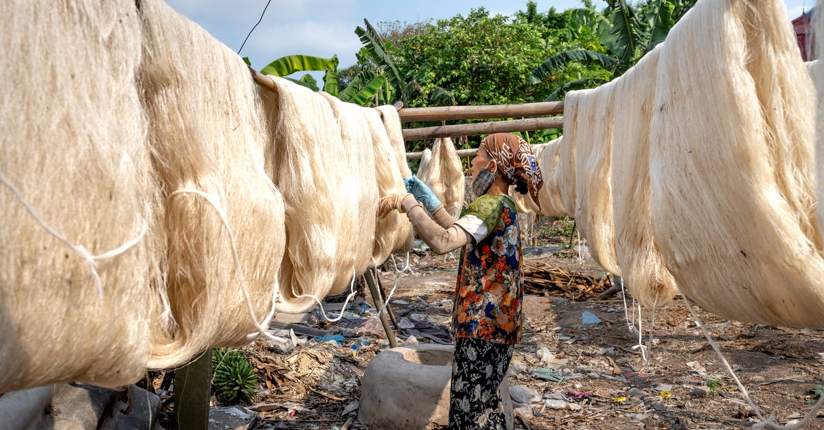 Layover in Addis Ababa: need to collect checked luggage? - Asian woman checking drying silk threads