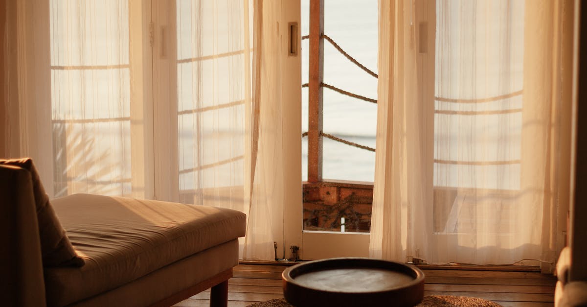 Leaving belongings in a capsule hotel - Black Round Table Near White Window Curtain