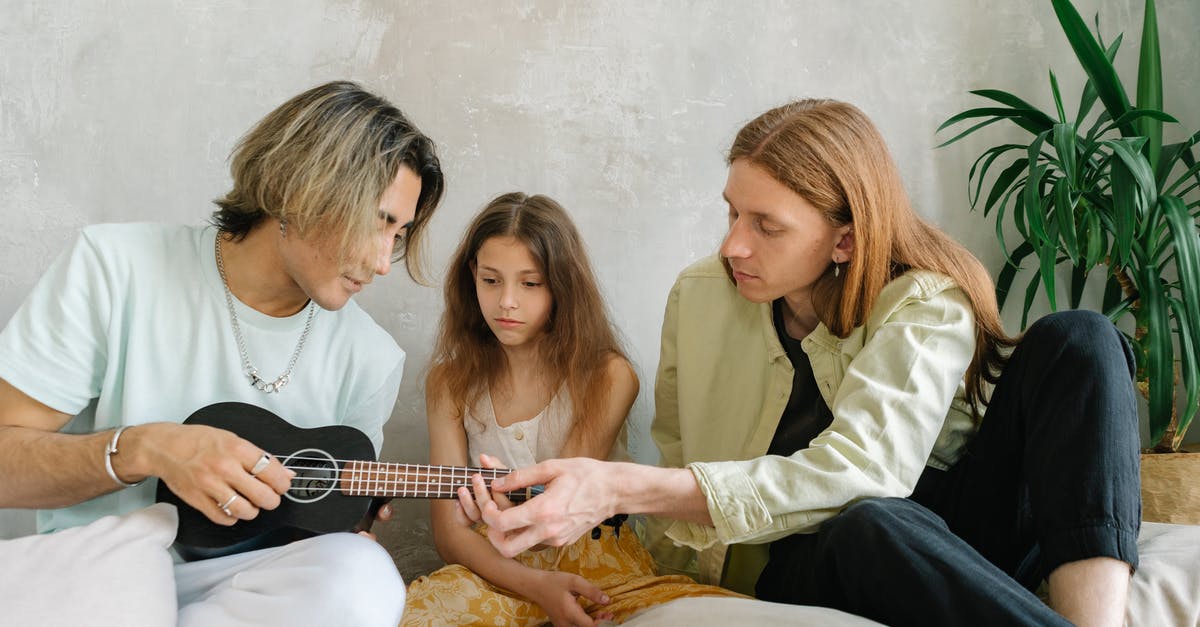 Leaving Canada - sole parent with child consent - Woman in White Long Sleeve Shirt Holding Black Acoustic Guitar