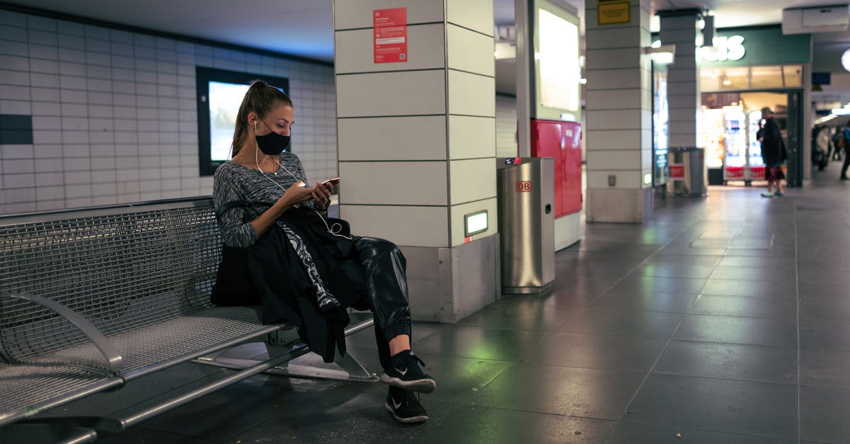 Leaving Riga airport at intermediate stop - Man in Black Jacket Sitting on Black Chair