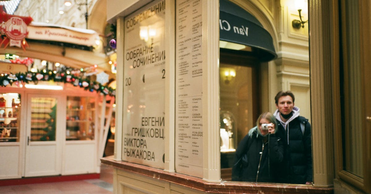 Leaving Russia to Schengen - which Ukrainian passport to use? - Couple taking picture and reflecting in mirror on street