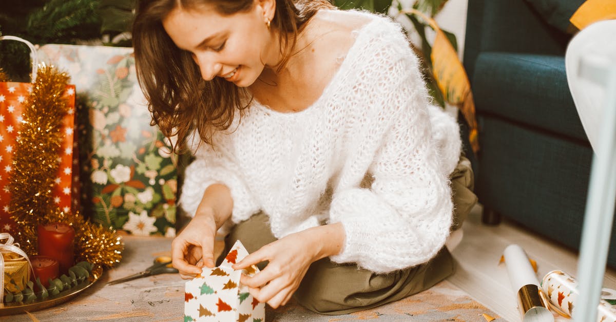 Leaving the airport during a long layover [closed] - Young Woman Wrapping Christmas Gift in Decorative Paper