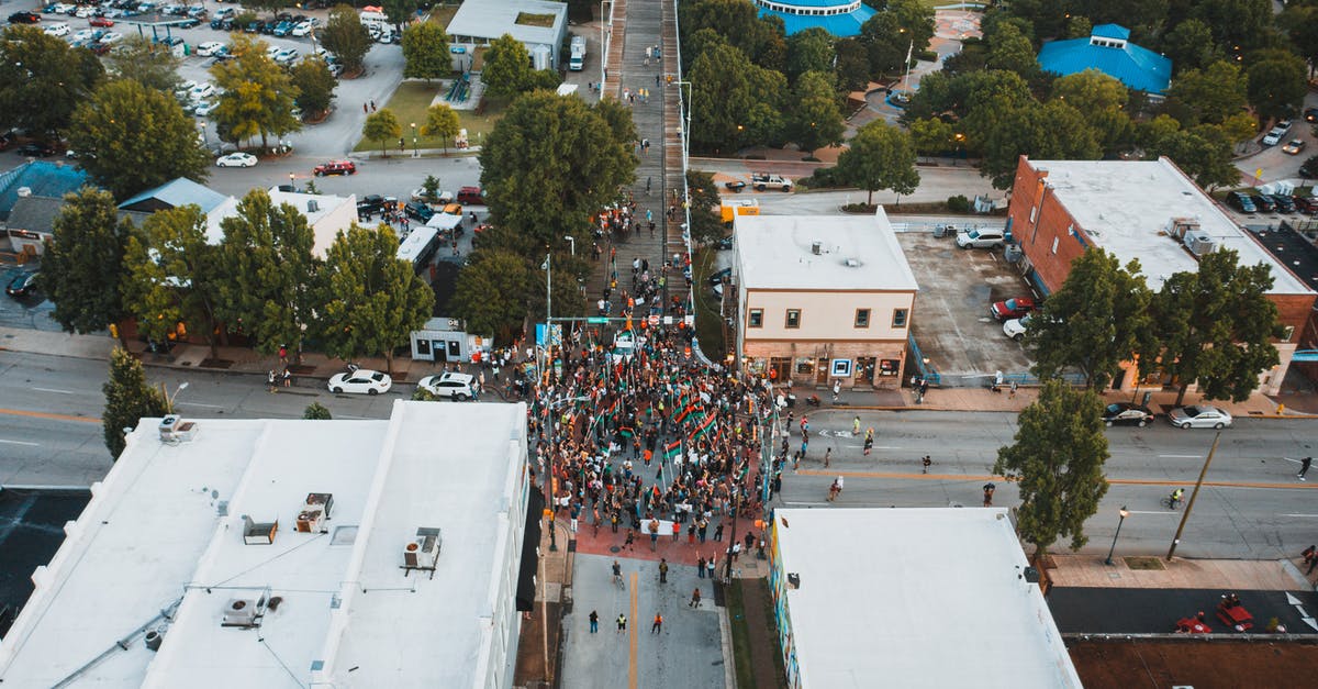 Left/right right of turn on an intersection in USA - Crowd of people in demonstration on city road