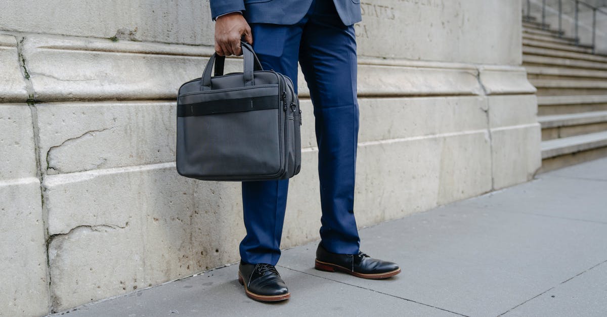 Legality of carrying spent ammunition - Man in Blue Suit Jacket and Blue Denim Jeans With Black Sling Bag