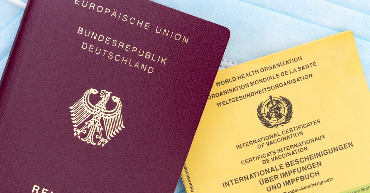 Living in the UK with German passport, but going abroad with Brazilian passport. Will this be a problem to reenter the UK? - Brown and Yellow Book on Blue Textile