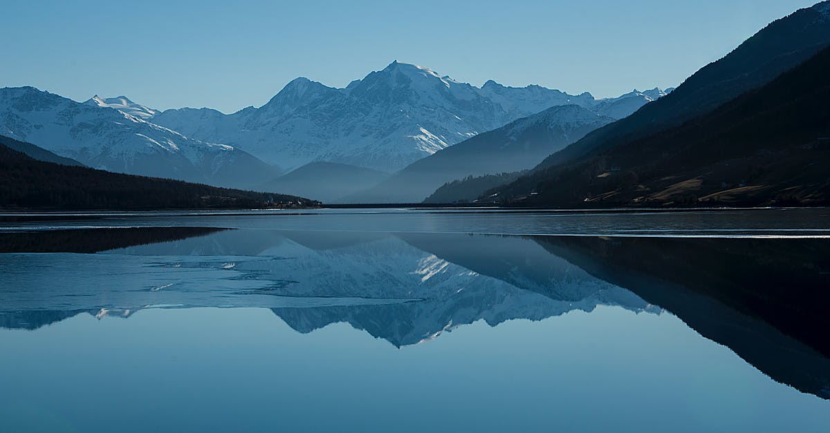 Location of photo used for Windows 10 desktop background? [duplicate] - Calm Body of Lake Between Mountains