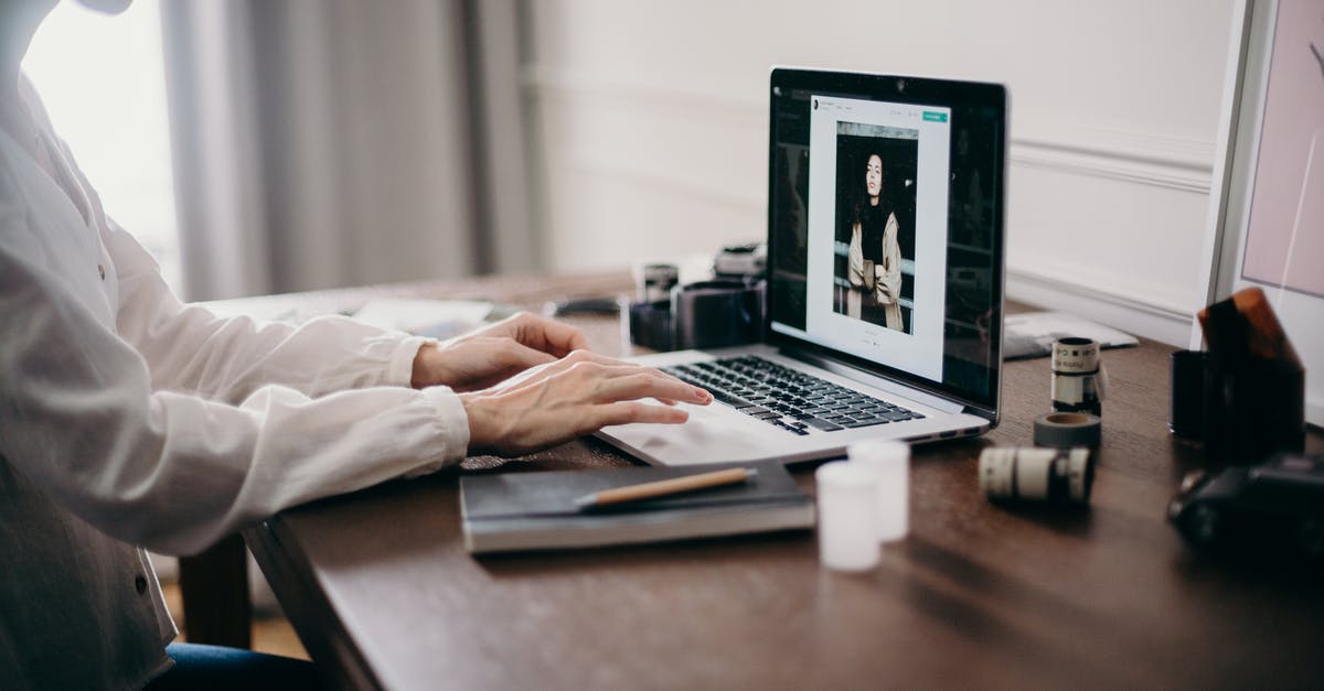 Location of photo used for Windows 10 desktop background? [duplicate] - Selective Focus Photography of Woman Using Macbook Pro