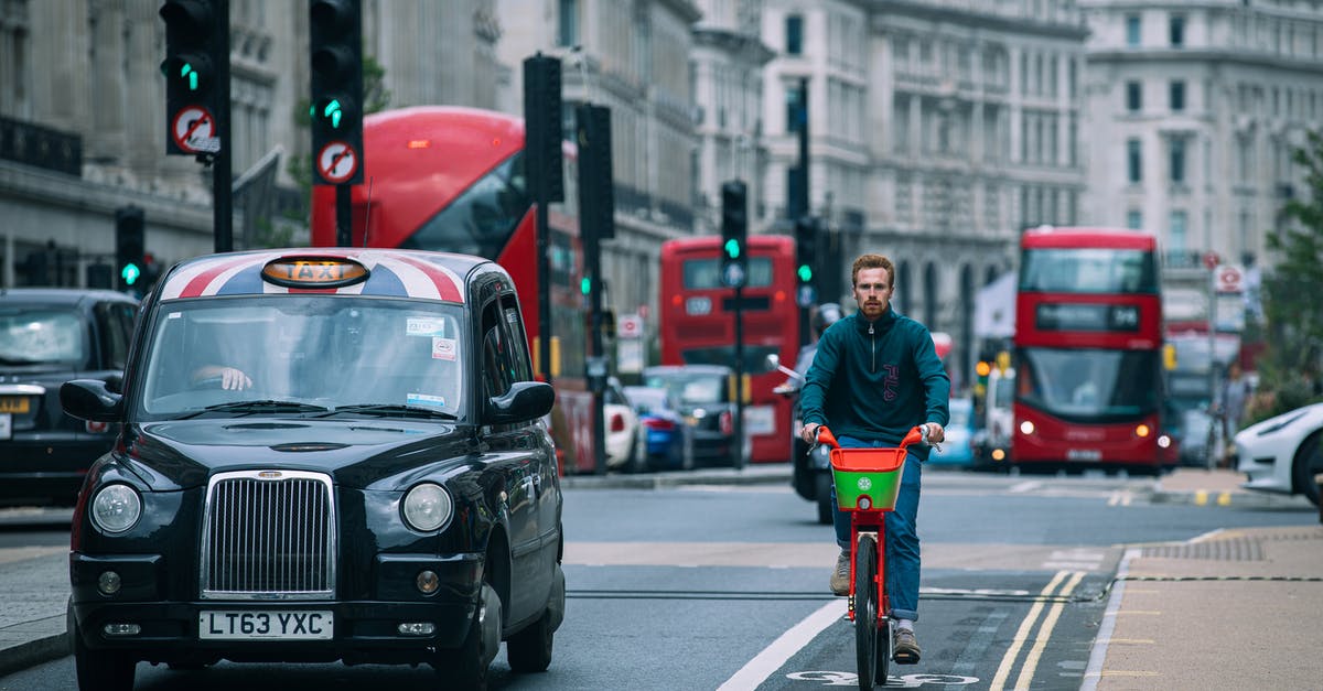 London cycle hire without chip-and-pin - Man in Green Jacket Riding Bicycle on Road