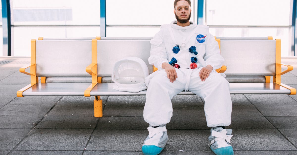 London Heathrow T3 immigration waiting time? - Man In An Astronaut Costume SItting On A Bench