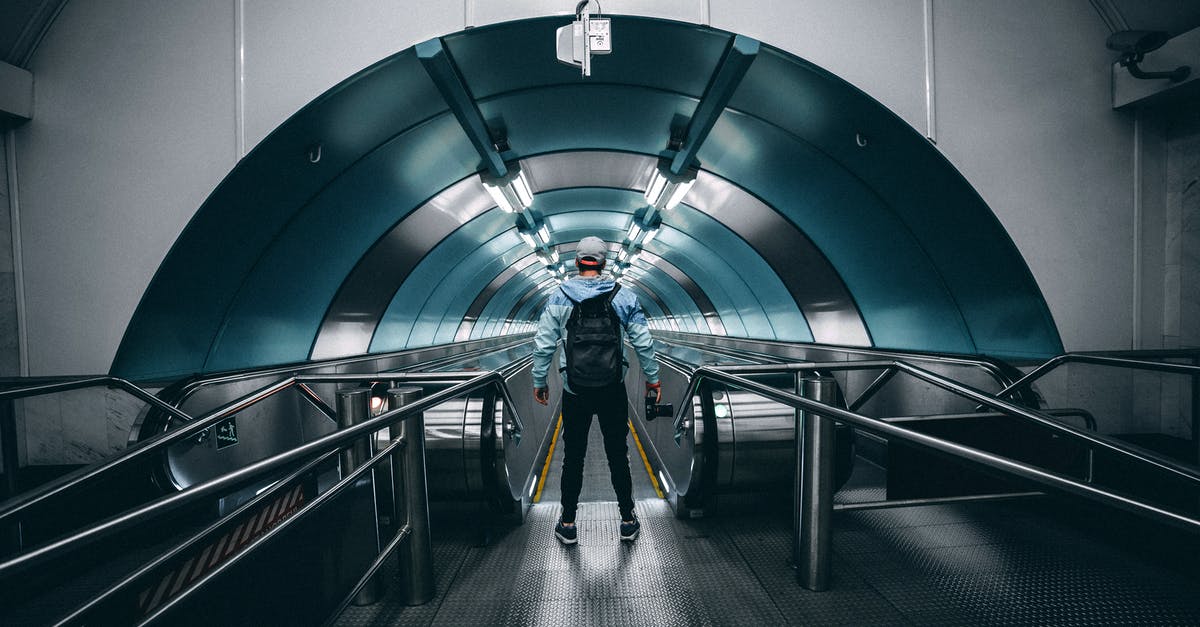 London to Stonehenge to Bath to Portsmouth back to London - Back View of a Person Standing in Front of a Moving Walkway