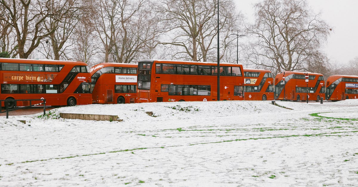 London Tour Buses - Red Double Decker Buses Near Snow-Covered Ground