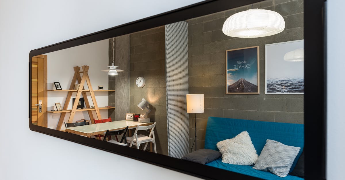 Long term accommodation proof for Schengen visa [closed] - Interior of cozy modern living room with comfortable couch and big table reflected in narrow long mirror