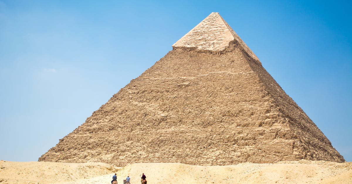 Long transit in Cairo (Egypt) - People Riding A Camel Near Pyramid Under Blue Sky