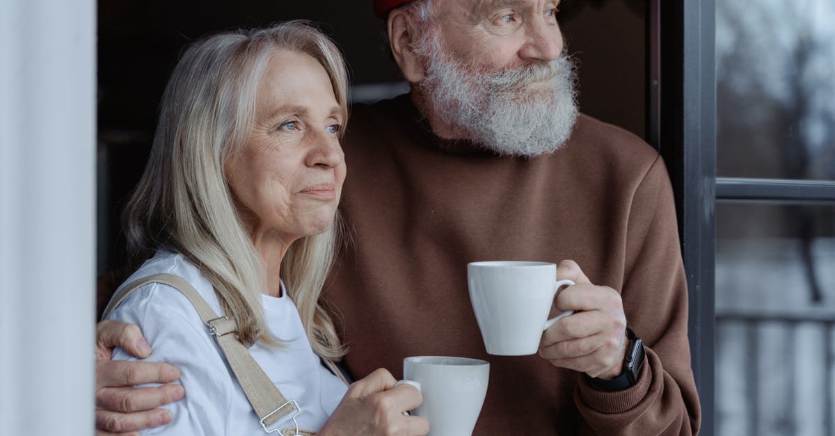 Longer EU stay for retired couple - Man and Woman Holding White Ceramic Mugs