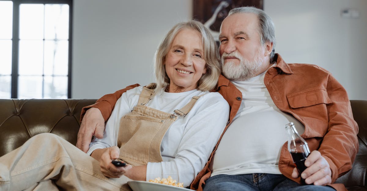 Longer EU stay for retired couple - Man and Woman Sitting on Couch