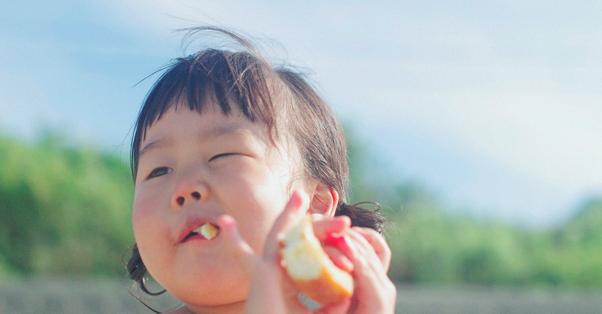 Long-term travel with a 3-month-old baby through a country? [closed] - Close-up Photography Of A Girl Eating Bread