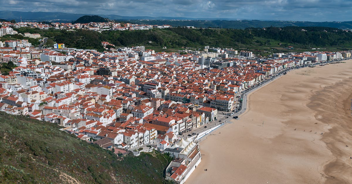 Looking for a small scenic beach town village in Spain or Portugal [closed] - Aerial View of City Buildings on Green Grass Field
