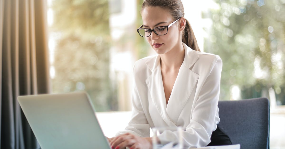 Looking for an adaptor to use my computer from France in Uruguay - Concentrated female entrepreneur typing on laptop in workplace