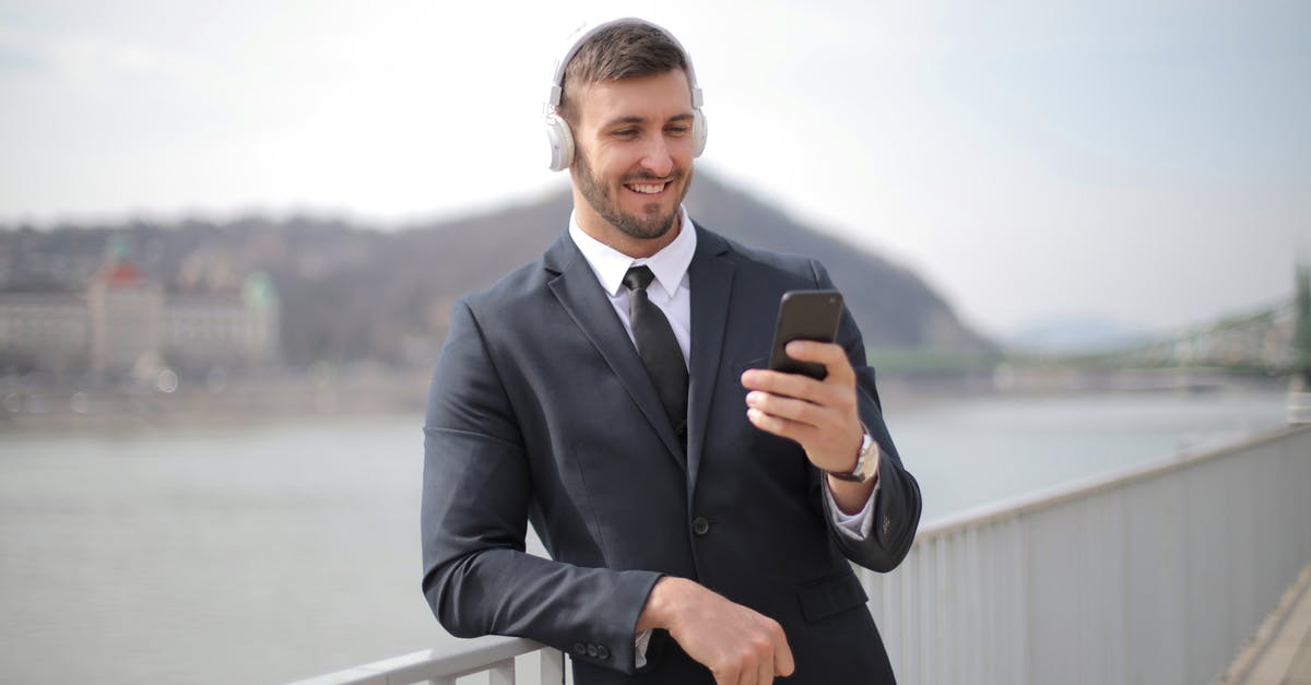 Looking for direct ship connection between Mainz and Lake Constance (Bodensee) - Man in Black Suit Jacket Holding Black Smartphone