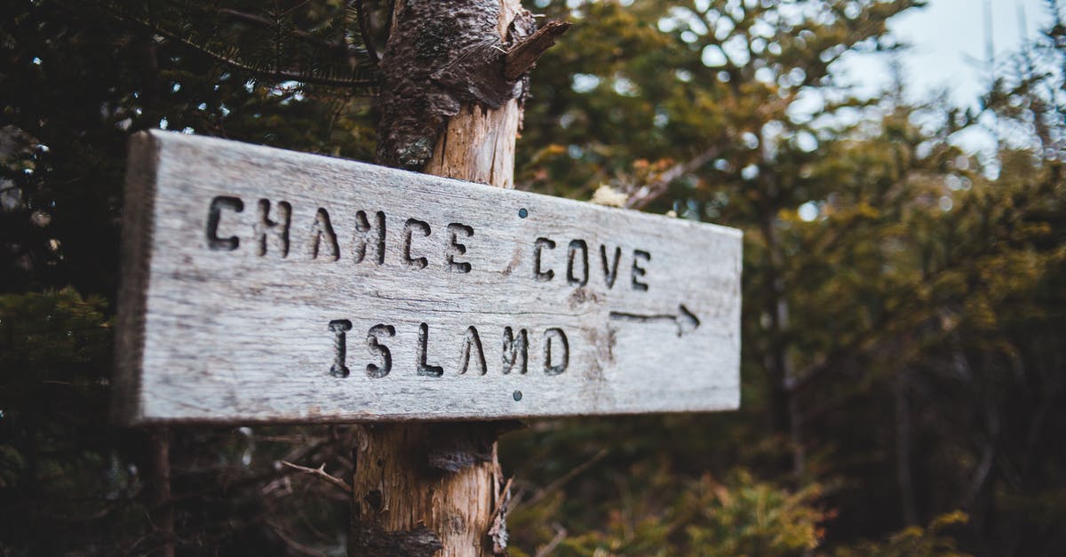 Lost my canada refusal letter [duplicate] - Sign on tree trunks with arrow and Chance Cove Island text