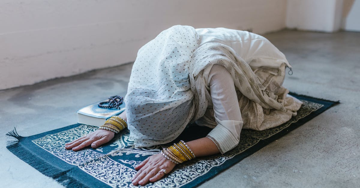 Lots of Muslim headscarfs on a Sunday in Hong Kong - A Woman Wearing a White Headscarf Bowing Down on a Prayer Rug