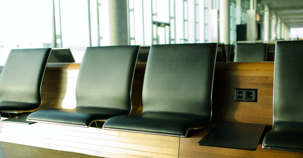 Lounge access on arrival at Singapore airport Terminal 2 - Brown Wooden Frame Black Leather Cushion Bench