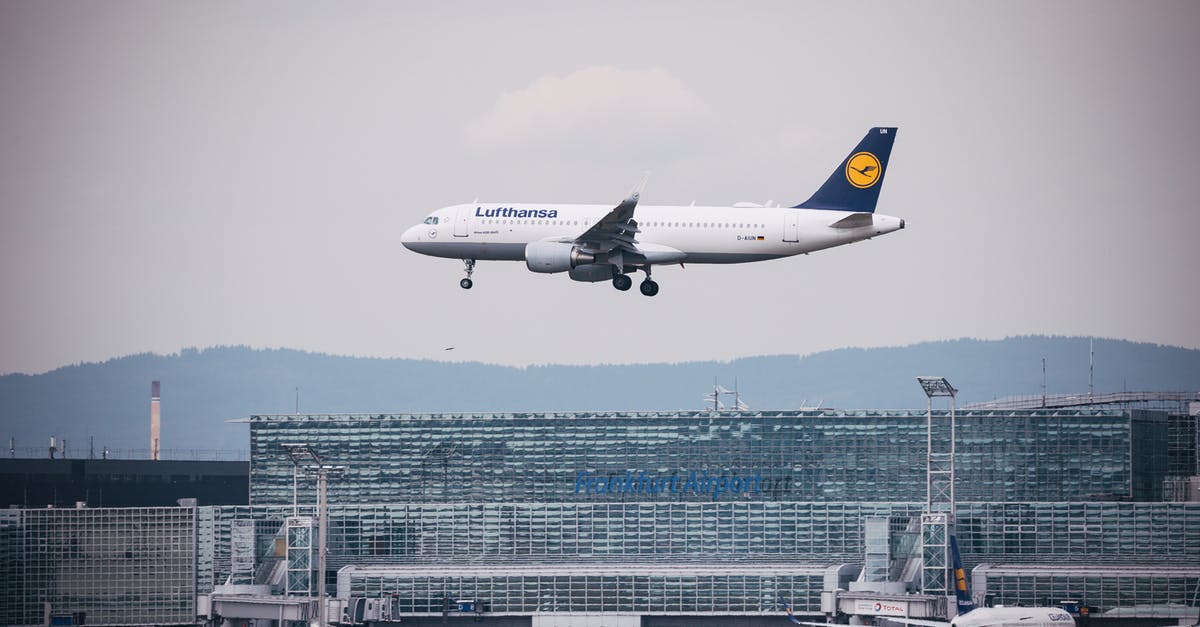 Lufthansa - Rail & Fly at Frankfurt Airport - An Airplane Flying Over the Building