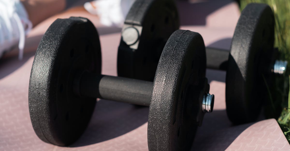 Luggage Allowance - Averaging the weight - El Al - Black and Gray Dumbbells on Brown Carpet