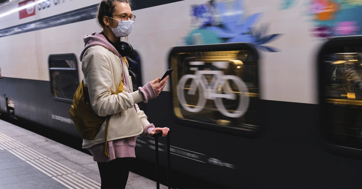 Luggage limit when travelling between Krakow and Warsaw by train - Woman With a Face Mask Waiting for a Train